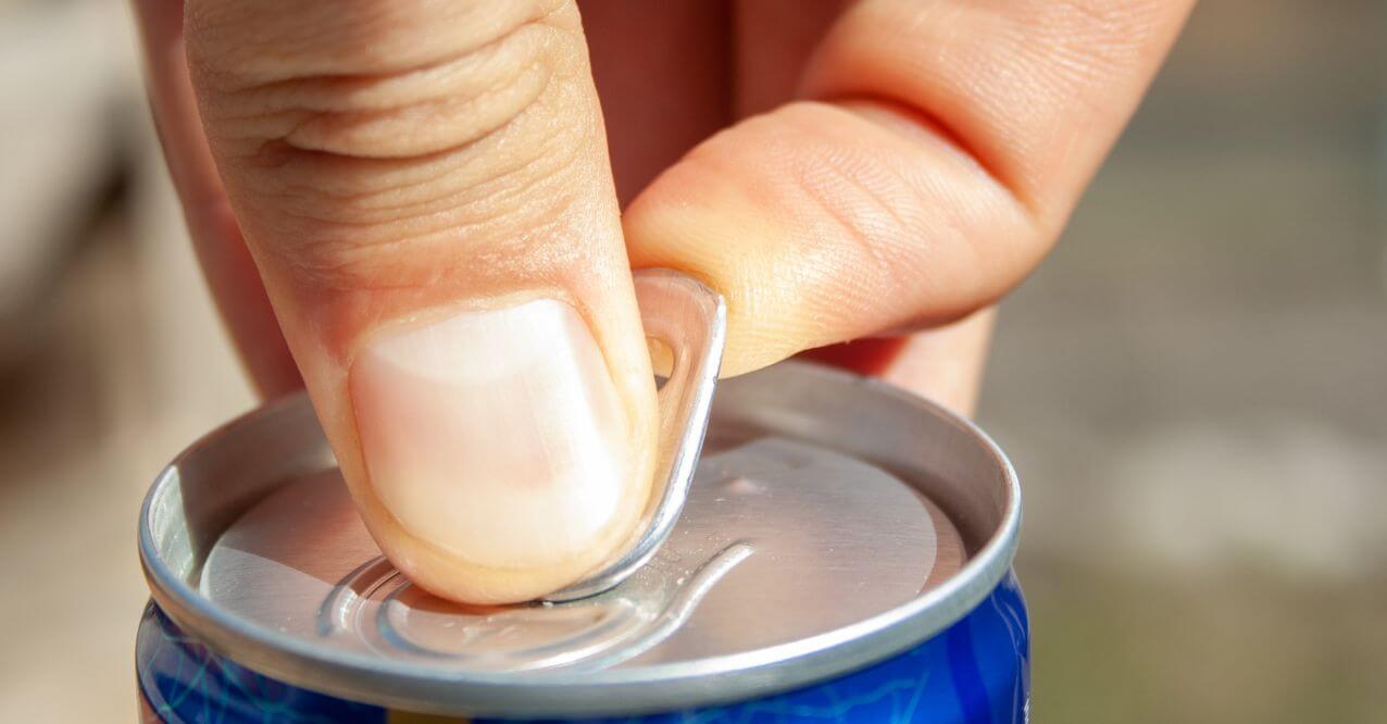 A hand opening a can of healthy substitute for energy drinks'.