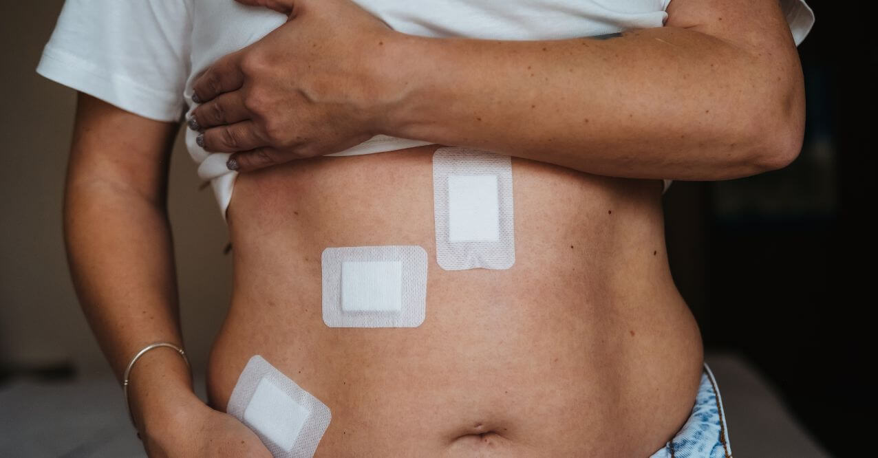 A person holding their abdomen with bandages, resembling 'Liver Problems After Gallbladder Removal'.