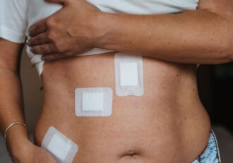 A person holding their abdomen with bandages, resembling 'Liver Problems After Gallbladder Removal'.